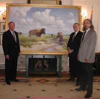Senator Charles Ford, WILLIAMS Manager of Governmental Affairs Chuck DeHart, and artist Wayne Cooper with the painting of the Tallgrass Prairie Preserve.