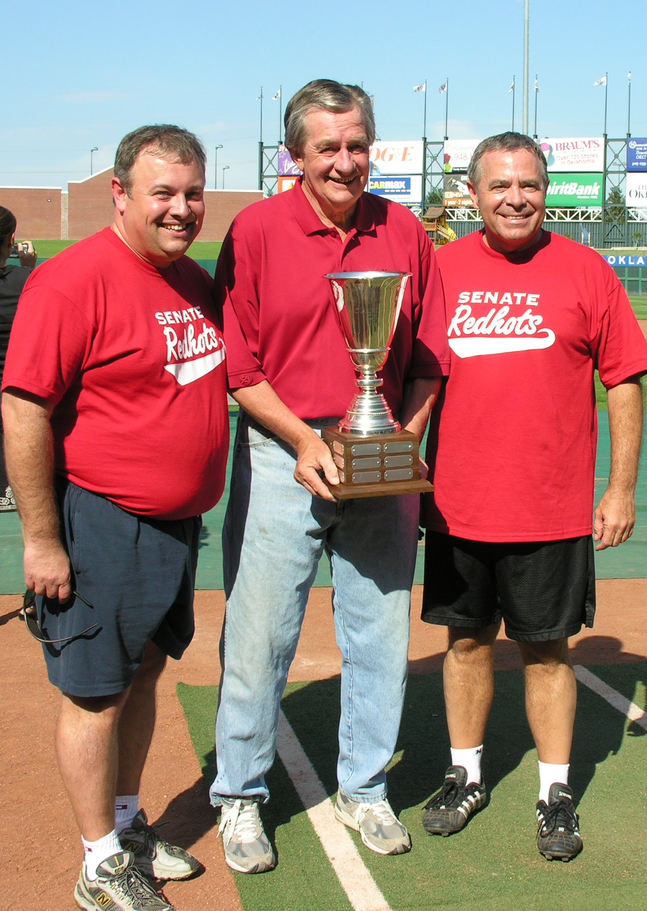 Senators Glenn Coffee, Ted Fisher and Mike Morgan are all smiles after the Senate Redhots enjoy their third straight win over the House at the Bricktown Ballpark.