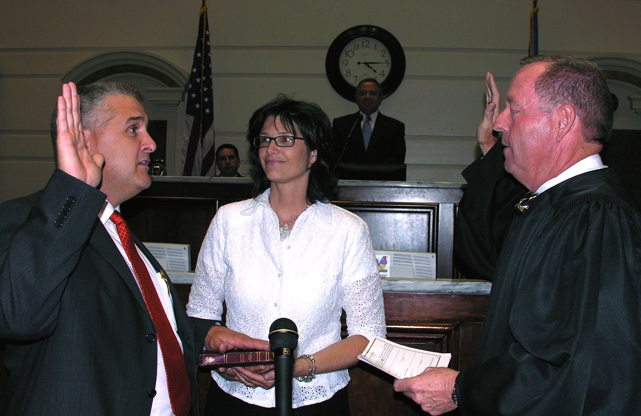 Senator Mike Schulz takes oath of office from Chief Justice Joseph M. Watt as wife Reenie Schulz looks on. 