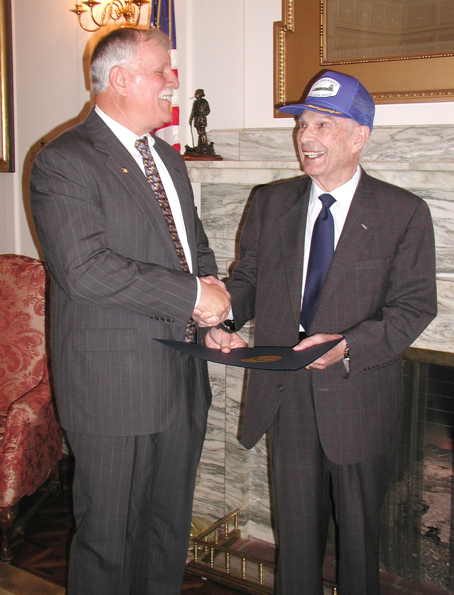 Sen. Garrison presents the resolution to Col. Hill.