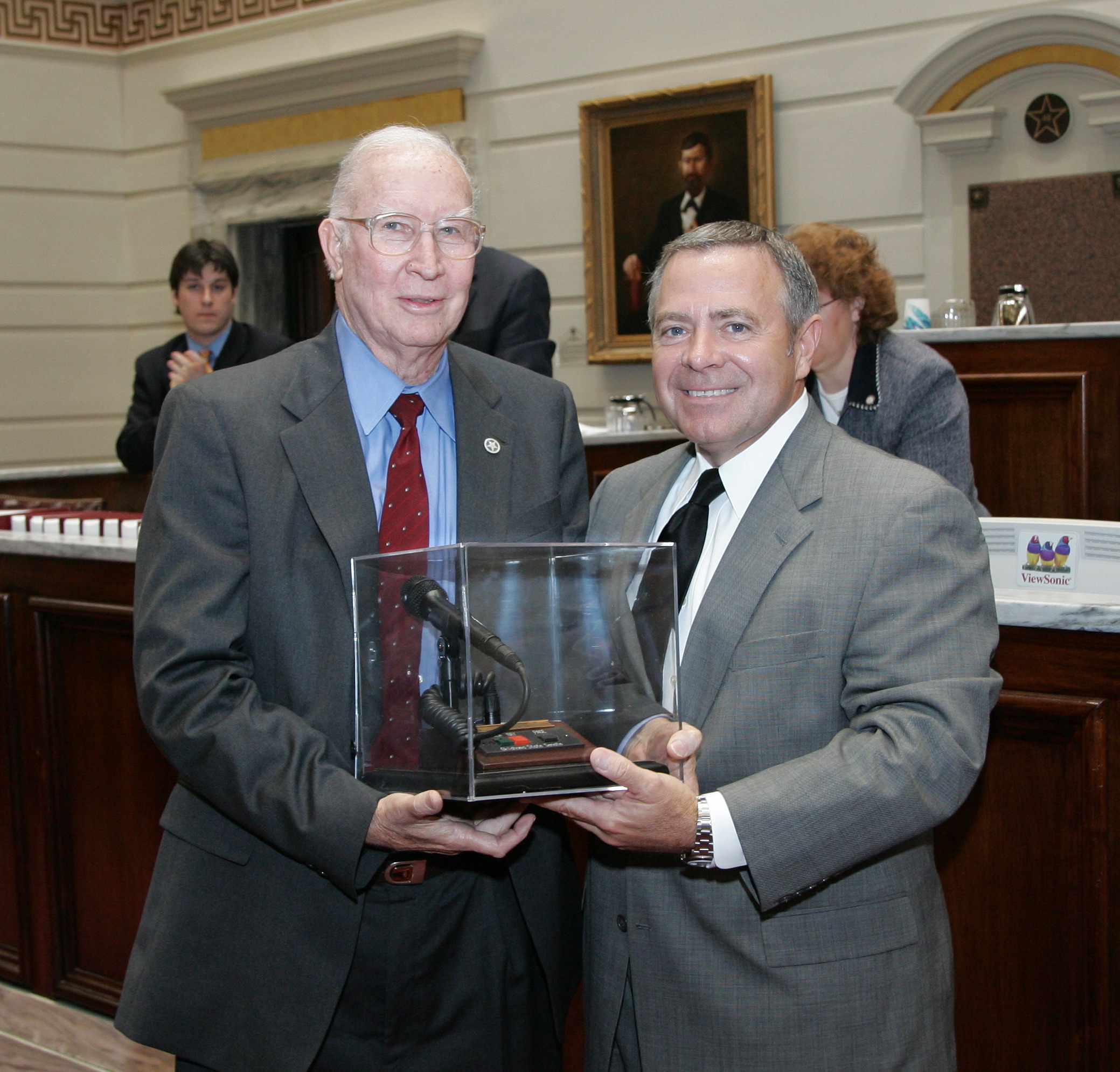 Senate President Pro Tempore Mike Morgan presents Senator Capps with his microphone.