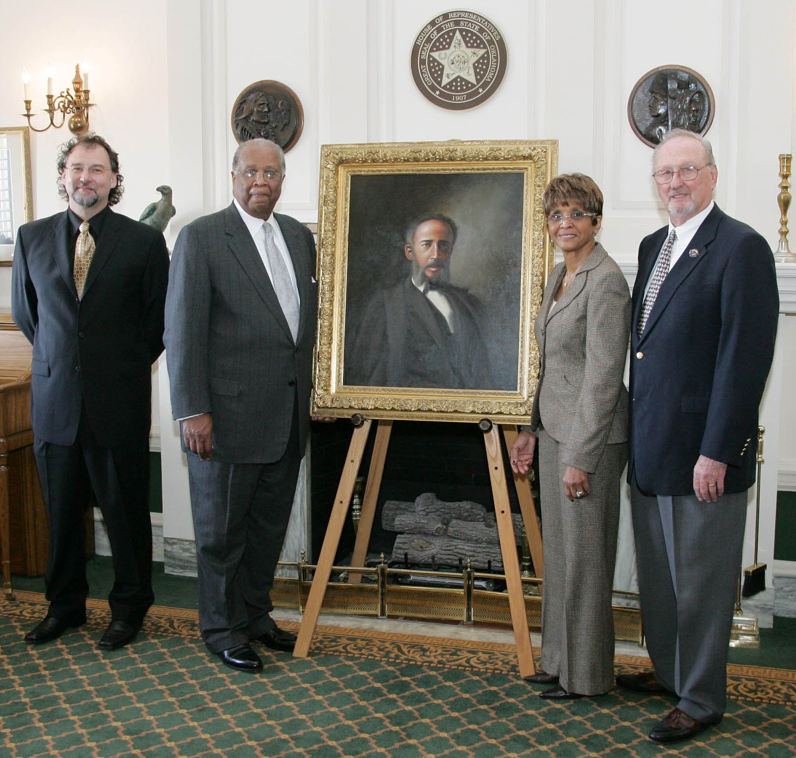Artist Timothy Tyler poses wtih sponsors Mr. and Mrs. Russell Perry and president of the Senate Historical Preservation Fund Charles Ford Wednesday following the unveiling of the portrait of Currin Green in the House Chamber.