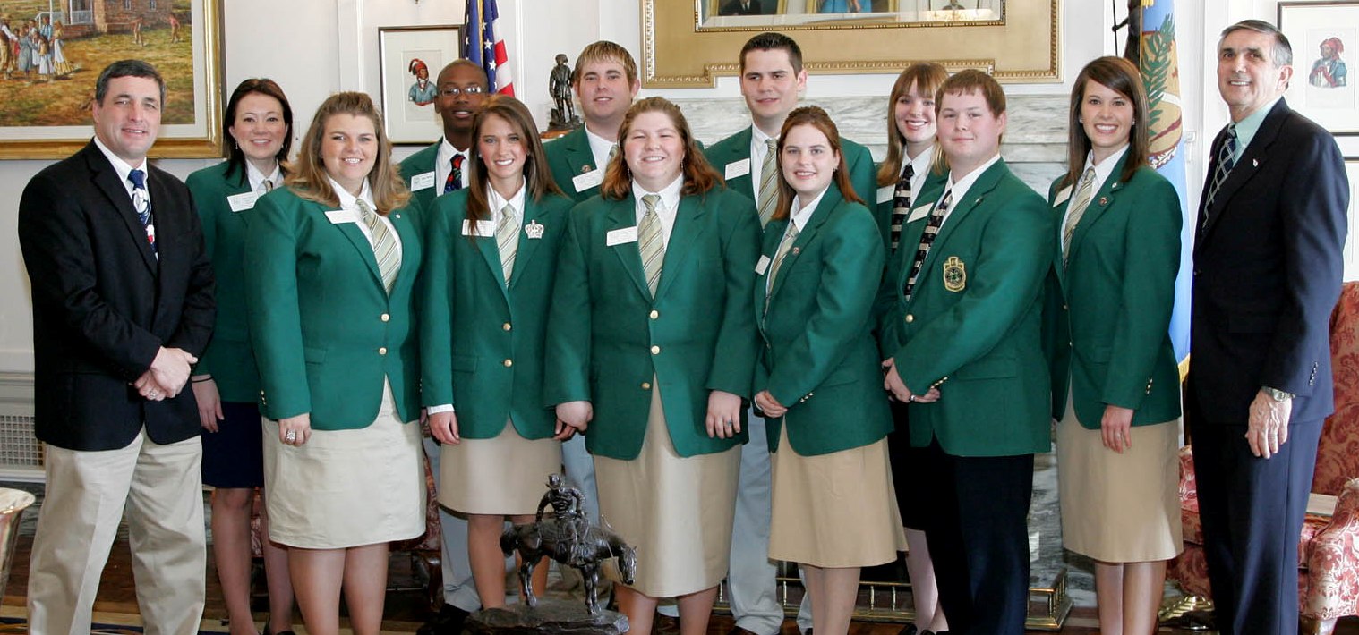 Senators Charles Wyrick and Ron Justice pose with state 4-H officers in the Senate lounge following the presentation of SR 25.