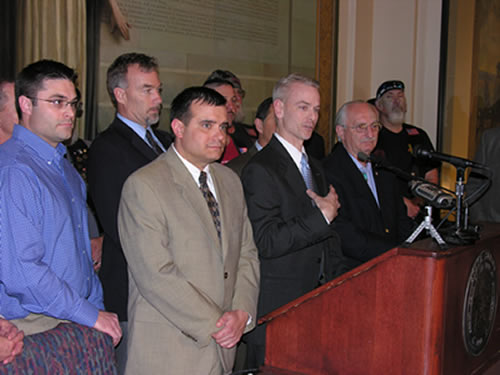 Sen. Steve Russell, flanked by Veterans and members of the Legislature, voices concerns regarding a recent report from the U.S. Department of Homeland Security.