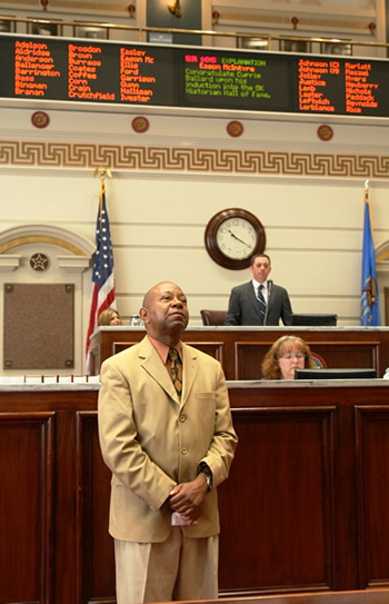 Currie Ballard listens as his resolution is read.